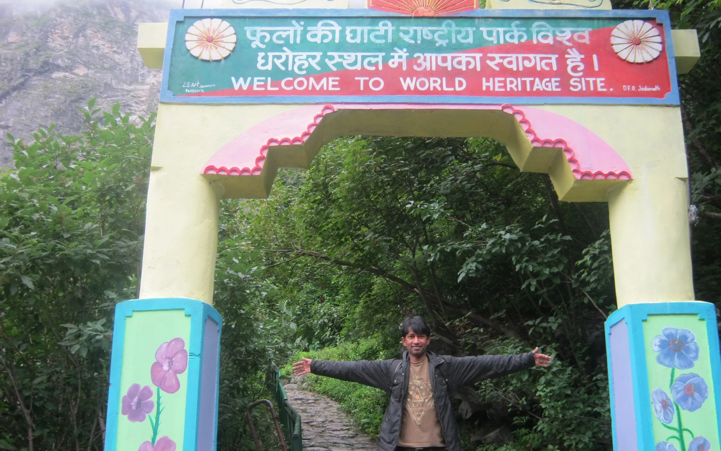 A trekker on the stone trail among the flowers inside the Valley of Flowers National Park, Chamoli